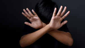 Kid showing hands doing stop gesture. The concept of stopping violence against children. Human Rights Day