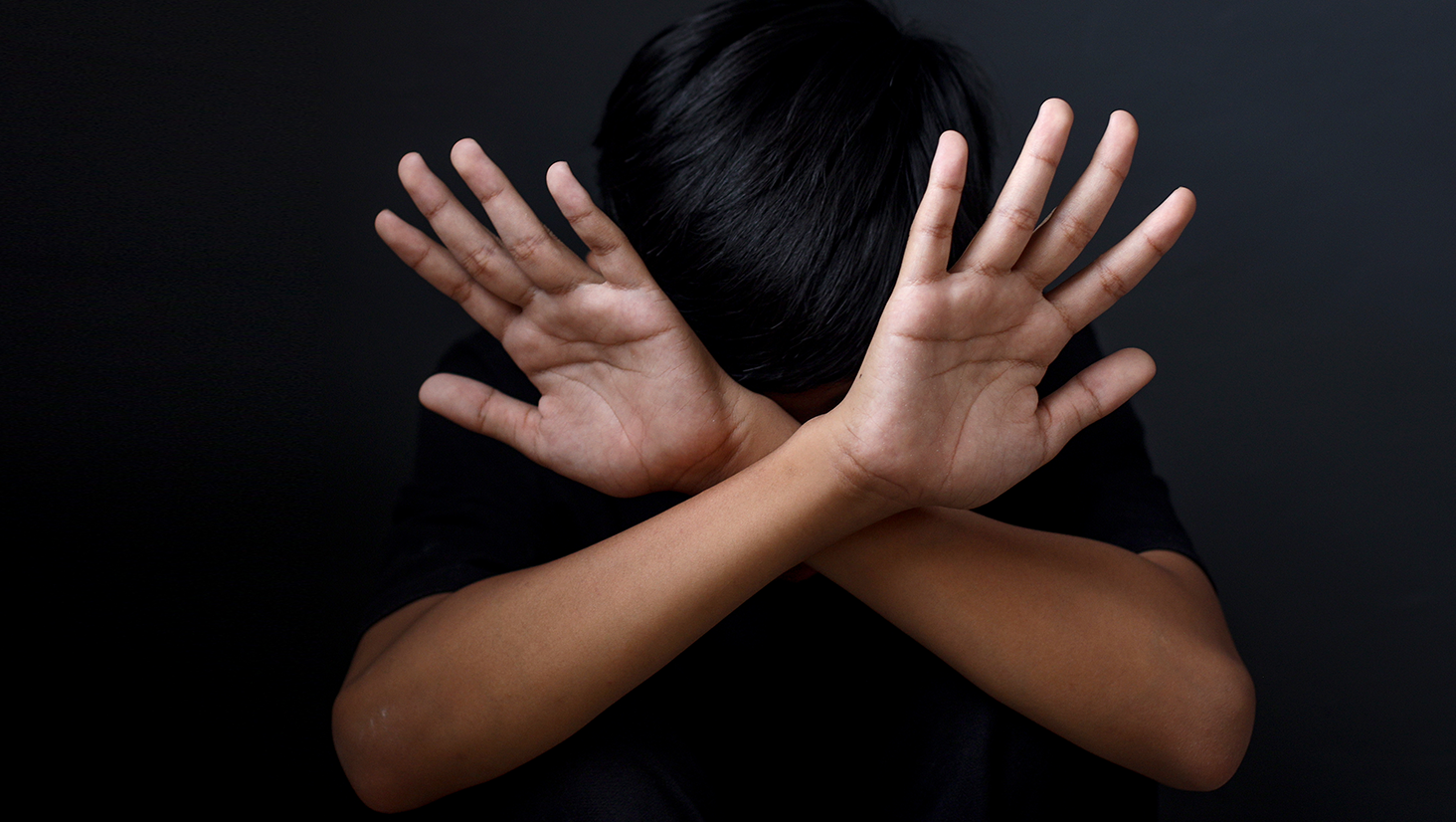 Kid showing hands doing stop gesture. The concept of stopping violence against children. Human Rights Day